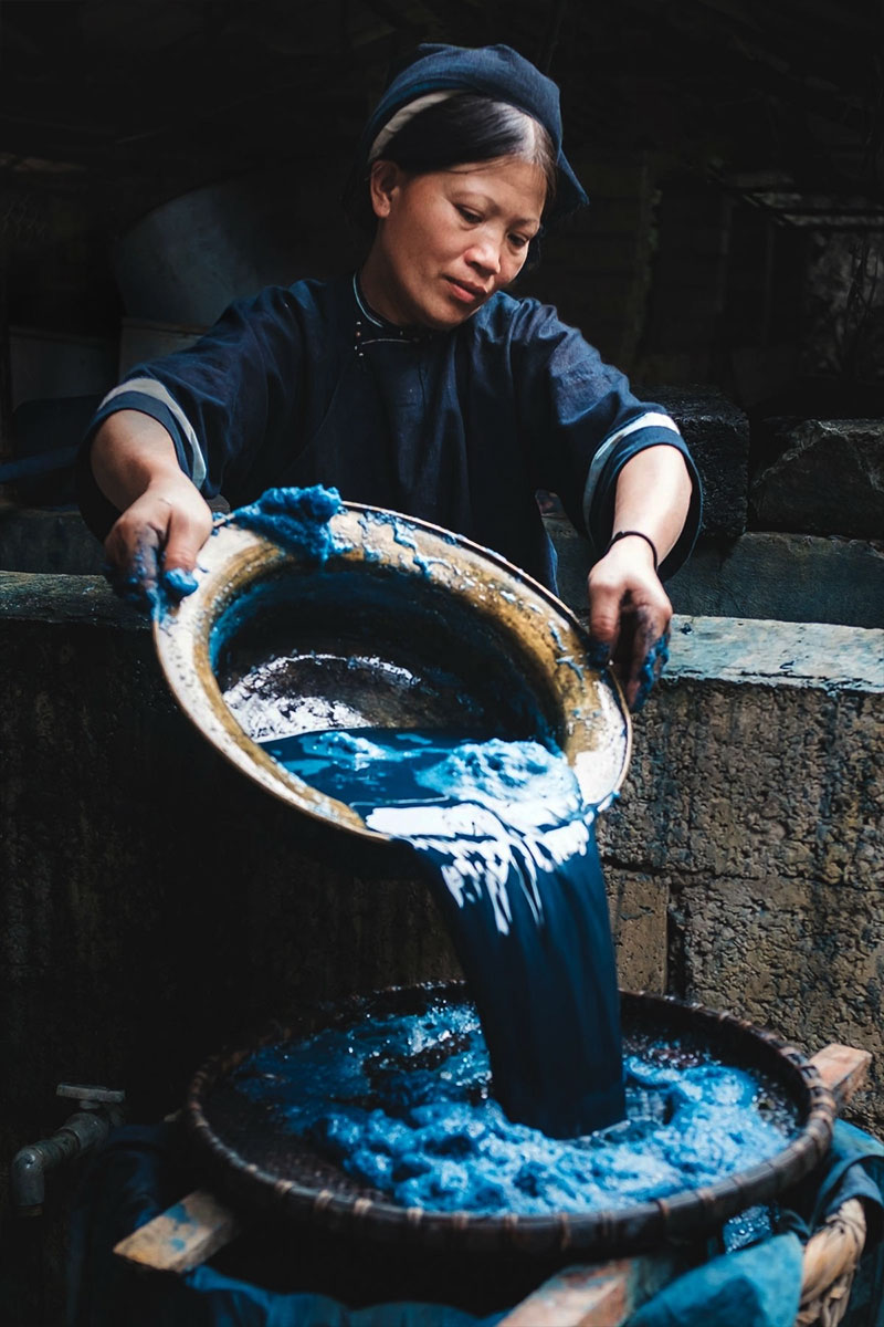 Chị So filters fermented indigo pigment as part of the dye extraction process.